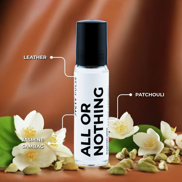 Roll-on bottle labeled 'All or Nothing' with leather, patchouli, and jasmine sambac notes on a brown background with flowers.