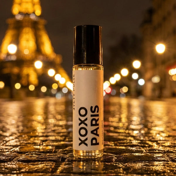 XOXO PARIS vegan perfume oil bottle on a wet street with the Eiffel Tower in the background