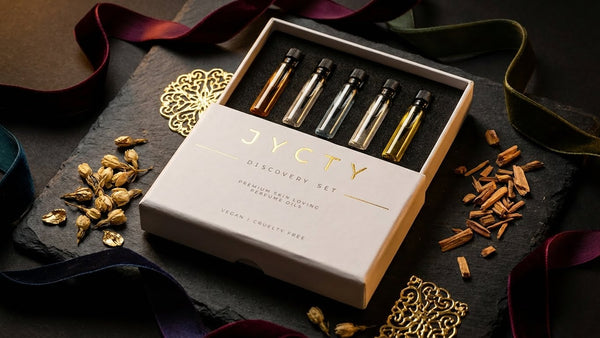 JYCTY discovery set with small perfume oil bottles and packaging on a dark surface